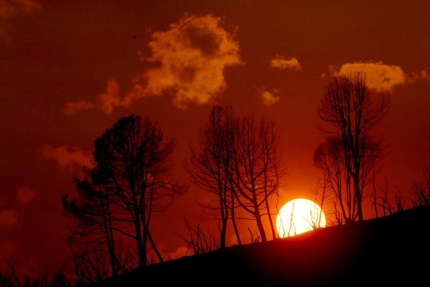 A red sunset over a hill.