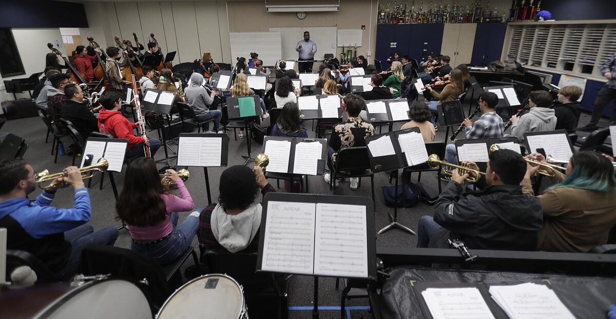 Guest director Anthony Parnther rehearses with the Burbank Unified All District Symphonic Orchestra for the upcoming "Music is Instrumental" performance at John Burroughs High School.