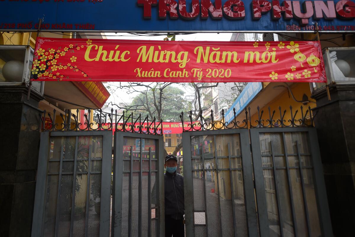 A security guard stands at the entrance of a primary school in Hanoi, Vietnam, where educational institutions have been closed since Feb. 3.