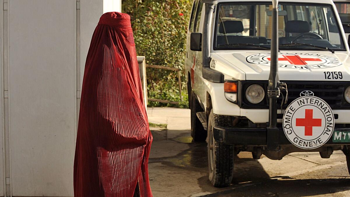 A pedestrian walks past a vehicle at the International Committee for the Red Cross office in Kabul in this 2008 photo.