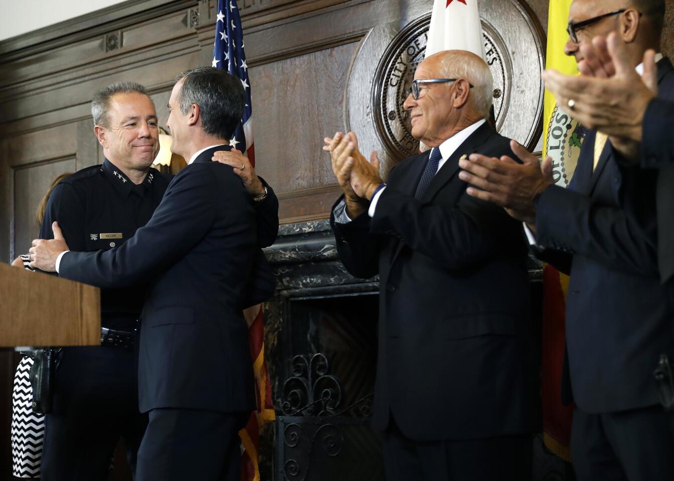Los Angeles Mayor Eric Garcetti announces LAPD Assistant Chief Michel Moore, left, as his choice to succeed Police Chief Charlie Beck, whose last day is June 27. Moore bested dozens of candidates for the position, including two other finalists with experience at the department.