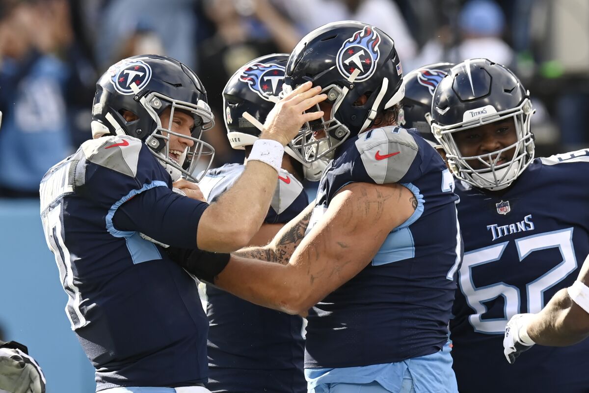 Tennessee Titans quarterback Ryan Tannehill, left, celebrates after scoring a touchdown on a 1-yard run against the New Orleans Saints in the first half of an NFL football game Sunday, Nov. 14, 2021, in Nashville, Tenn. (AP Photo/Mark Zaleski)