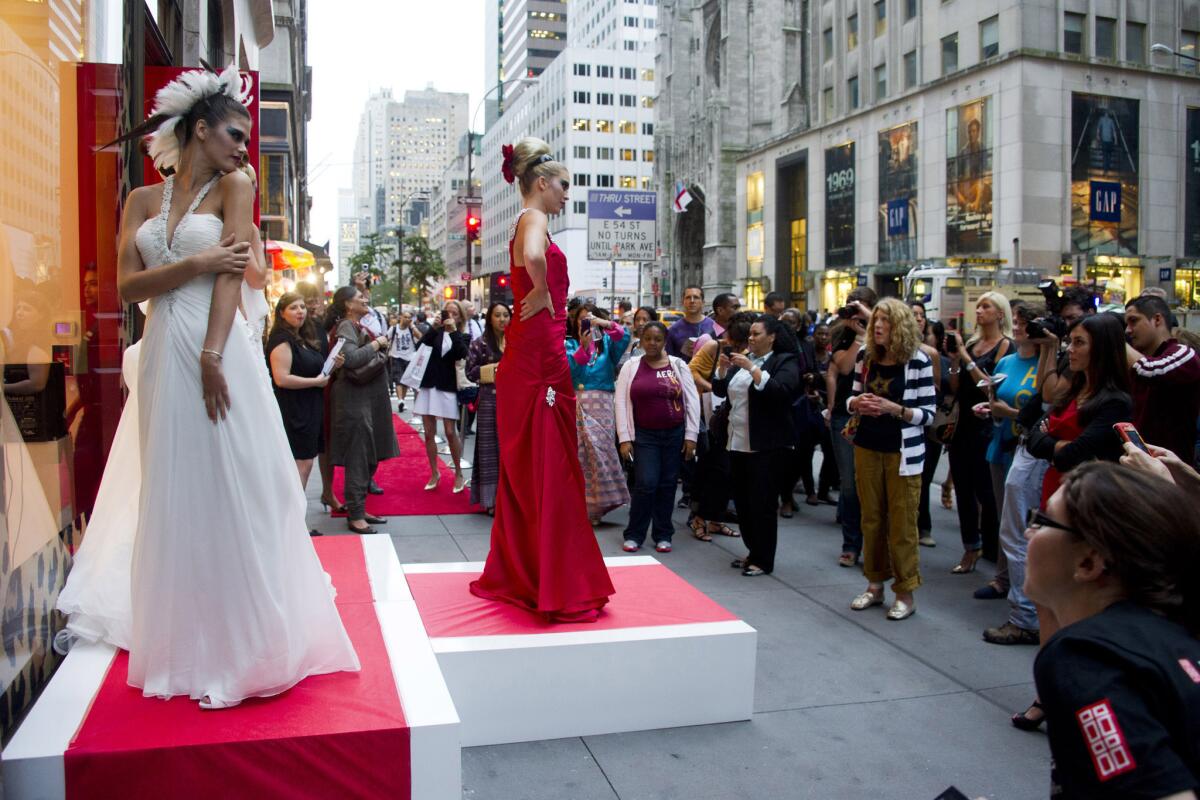 Models pose outside the Elizabeth Arden store on Fifth Avenue during Fashion's Night Out in New York. The annual event has been discontinued for 2013.