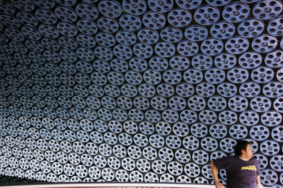 A wall and ceiling decorated with metal film reels.