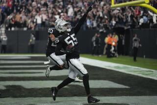 Las Vegas Raiders defensive end Chandler Jones celebrates after scoring on an interception.