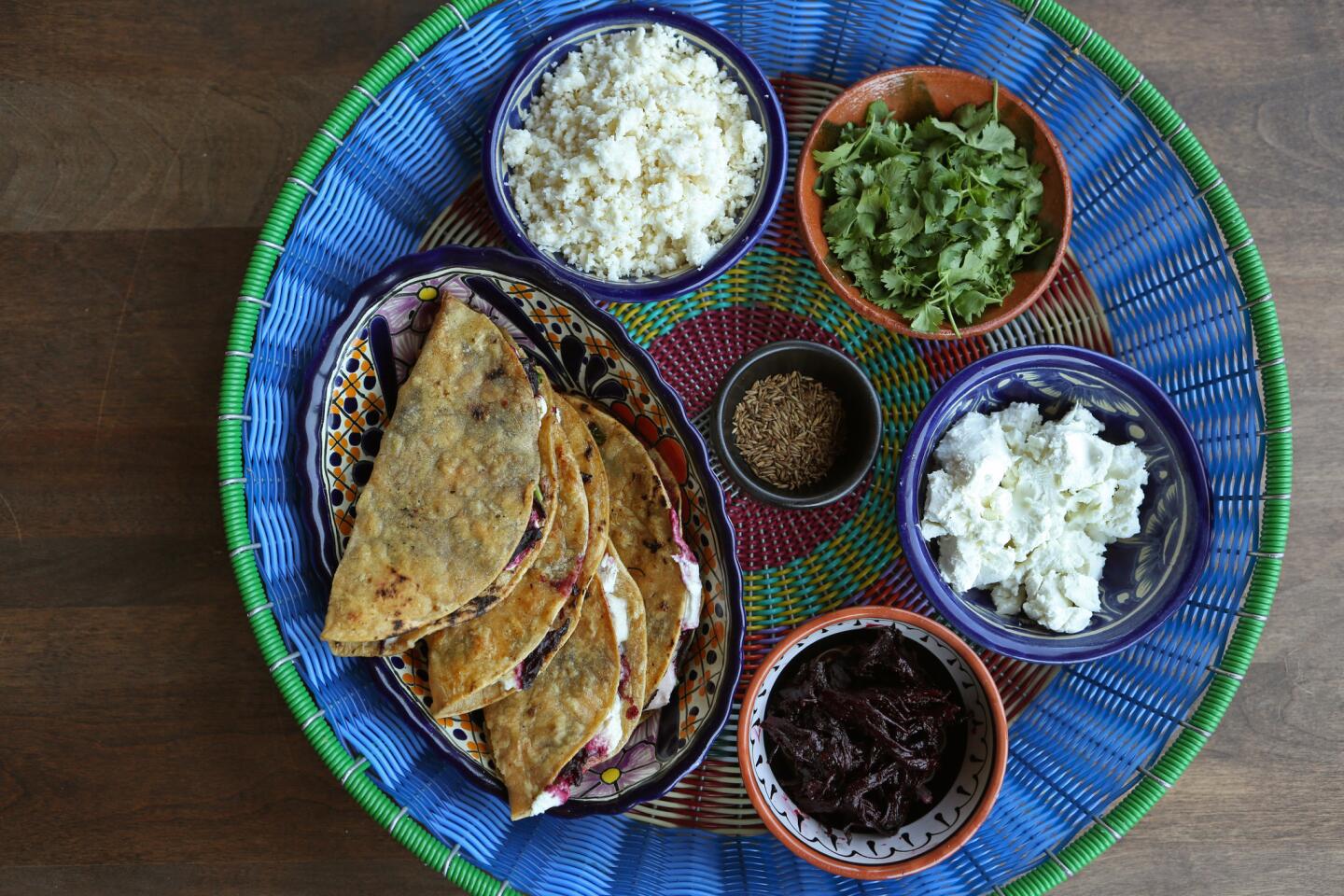 Quesadillas made with queso fresco, goat cheese, cilantro, cumin seeds and hibiscus braised in chicken broth and chipotle chili.