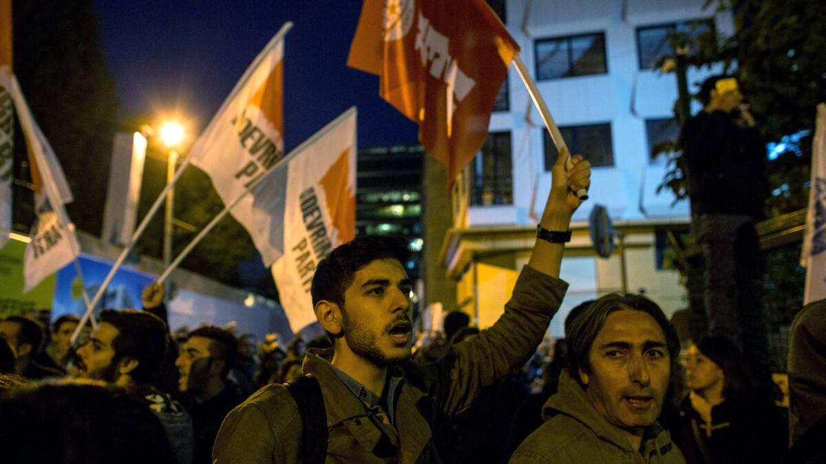 Protesters gather outside the Cumhuriyet newspaper office in Istanbul, Turkey, after 13 journalists, including the editor-in chief, were arrested.