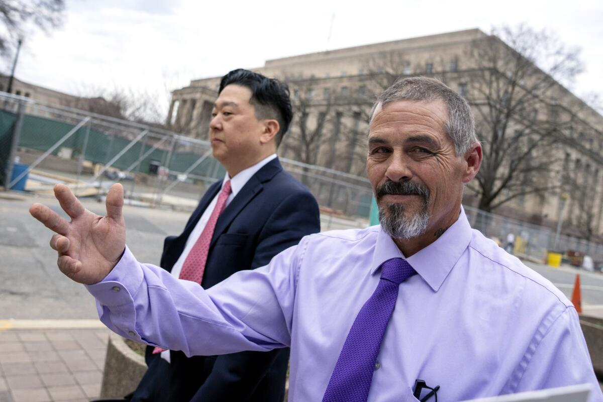 Kevin Seefried, right, a Delaware man who stormed the Capitol with Confederate battle flag, gestures