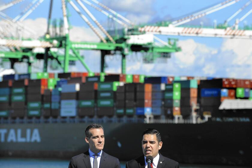 L.A. Mayor Eric Garcetti, left, and Long Beach Mayor Robert Garcia appear at a news conference Monday in San Pedro to celebrate the tentative deal between shipping companies and a union representing port workers.