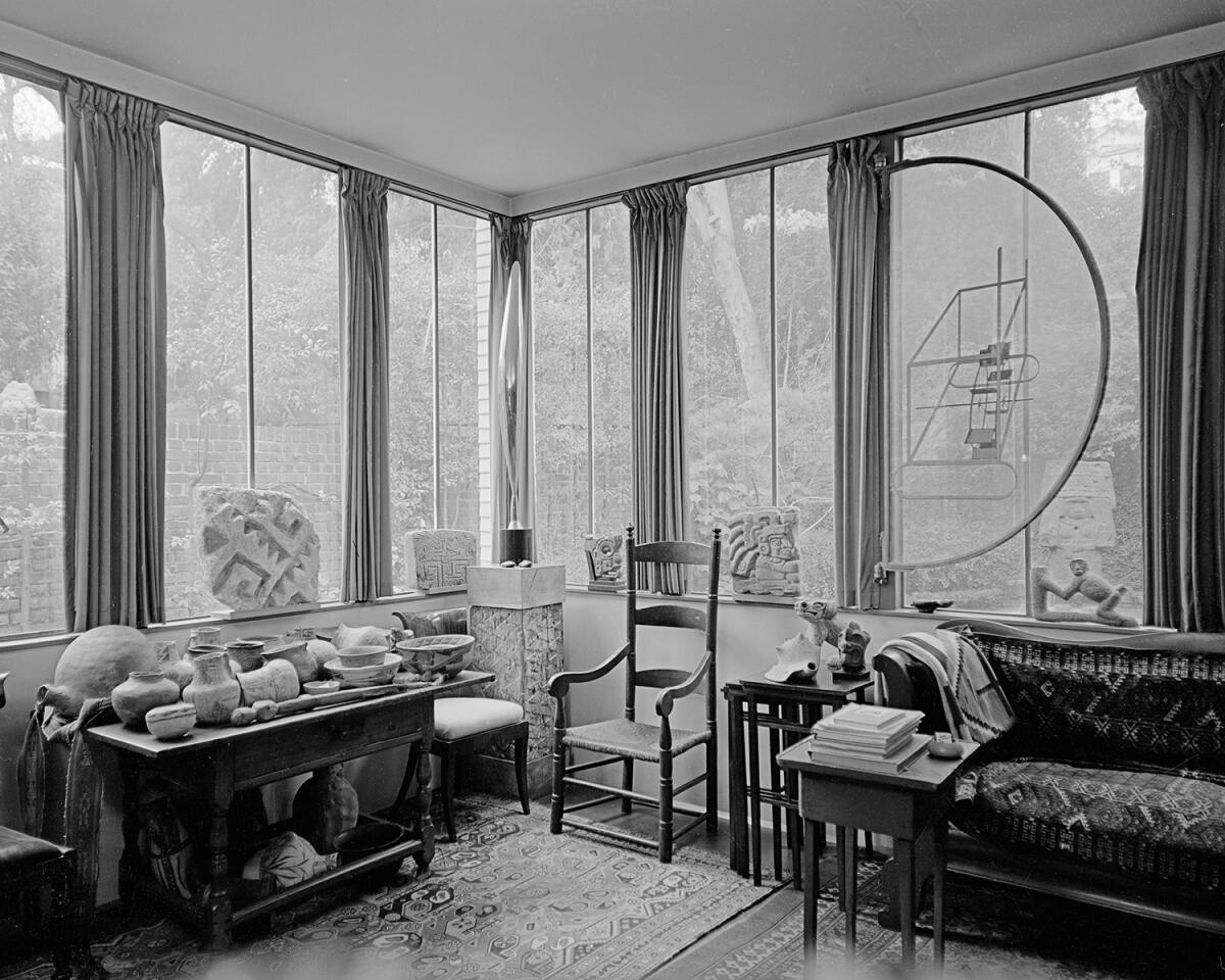 In the Arensbergs' Neutra-designed sunroom, a Duchamp relief on glass is installed in front of a window.