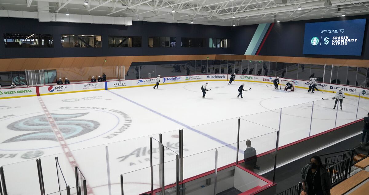 Seattle Kraken players take part in a practice session, Thursday, Sept. 9, 2021, during a media event for the grand opening of the Kraken's NHL hockey practice and community facility in Seattle. (AP Photo/Ted S. Warren)