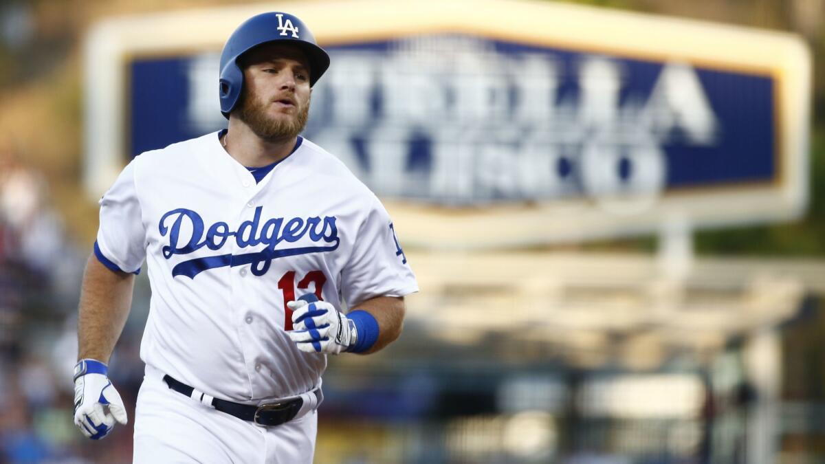 Dodgers first baseman Max Muncy rounds the bases after hitting a home run against the Angels at Dodger Stadium on Saturday.