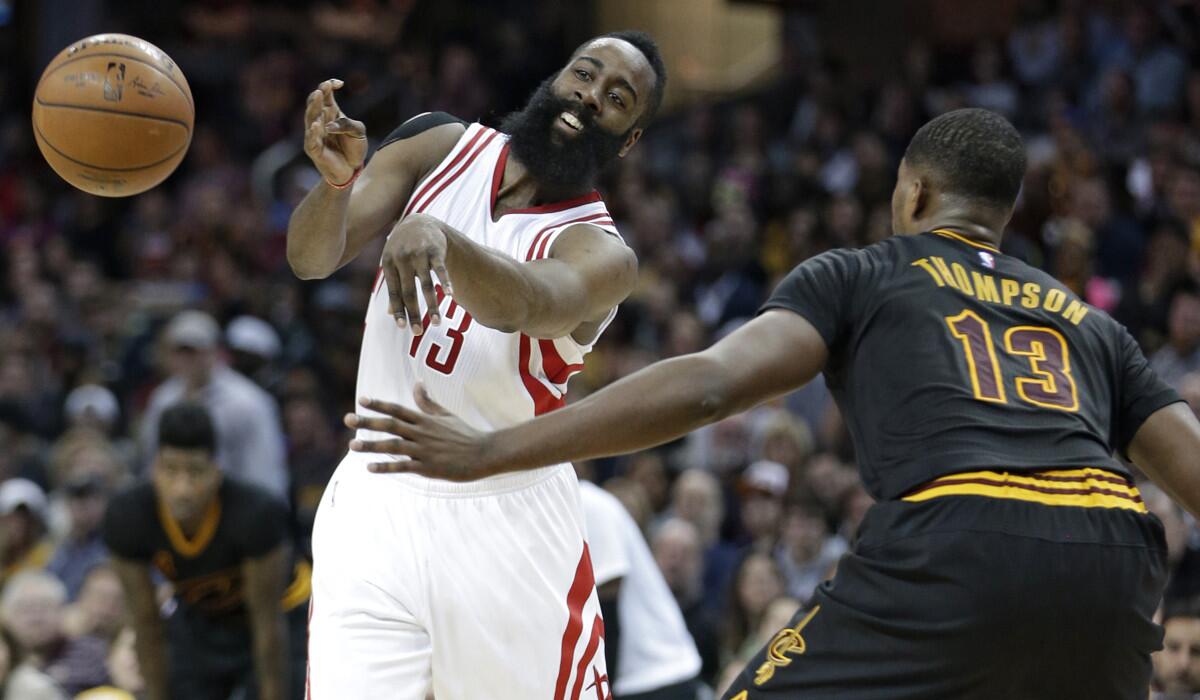 Houston Rockets' James Harden, left, passes against Cleveland Cavaliers' Tristan Thompson during the first half on Tuesday.