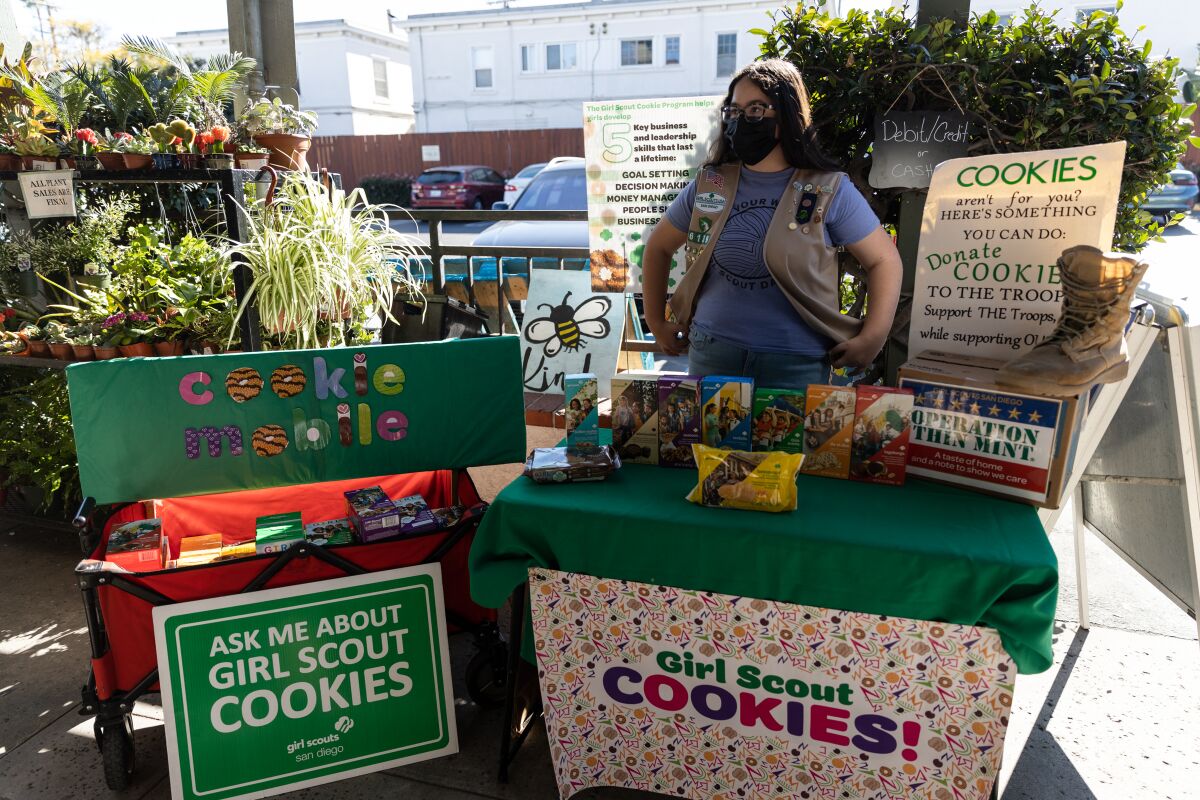 Girl Scout senior Ashley Hilliard, 14, sells cookies outside Boney’s Bayside Market in Coronado on Friday.