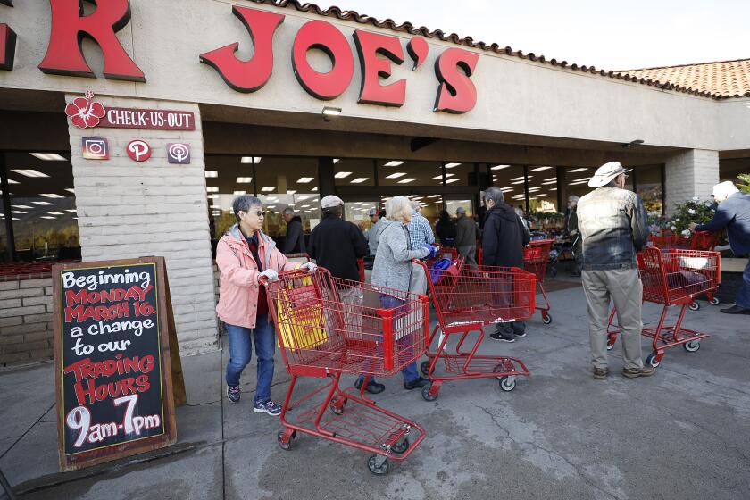 MONROVIA, CA - MARCH 17, 2020 Some confusion ensued as people arrived to wait in line to enter the Trader Joe's store in Monrovia as employees tell customers waiting in line that it would open doors to everyone at 9:00am, not only senior citizens. Senior citizens arrived believing doors would open earlier to older residents as some of the people were told by employees and it was reported. Some grocery outlets were offering special morning hours of shopping to accommodate older residents. (Al Seib / Los Angeles Times)