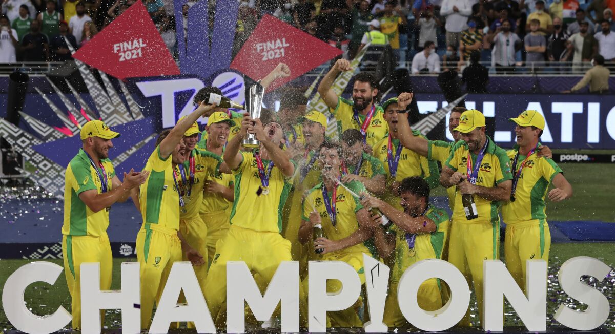 Australian cricketers celebrate after winning the Cricket Twenty20 World Cup final match in Dubai, UAE, Sunday, Nov. 14, 2021. (AP Photo/Aijaz Rahi)
