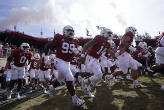Stanford players run onto the field before an NCAA college football game against Arizona State.