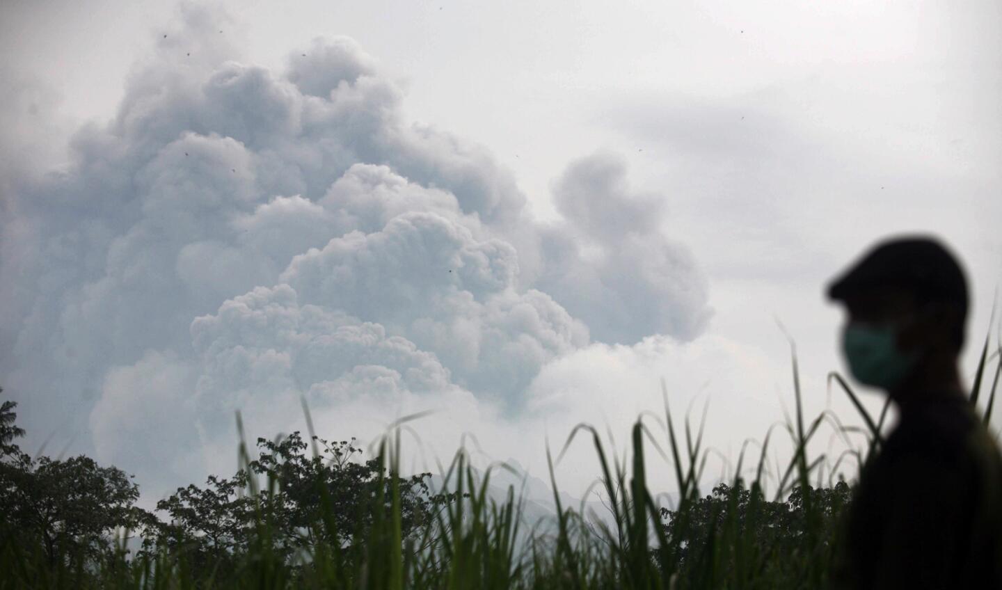 A man watches from Mbaladak village as Mt. Kelud erupts.