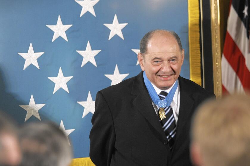Tibor Rubin receives a standing ovation in the East Room of the White House on Sept. 23, 2005, upon receiving the Medal of Honor from President George W. Bush.
