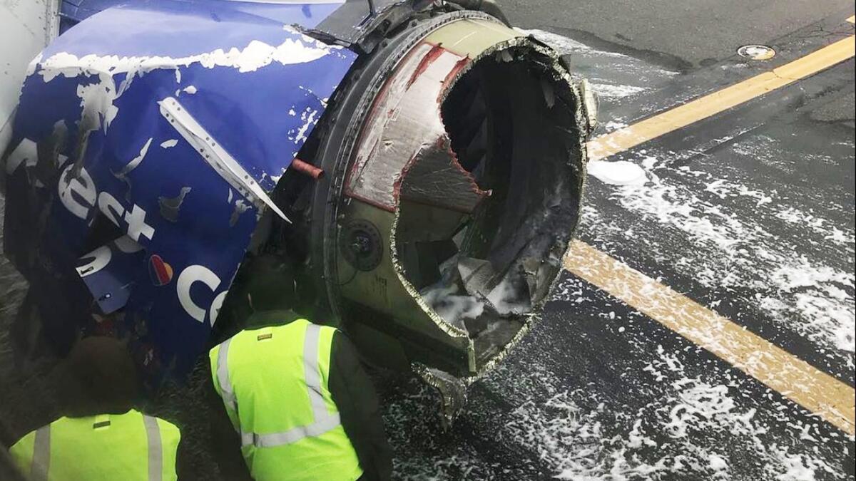 Officials inspect the engine that blew up on a Southwest Airlines flight, forcing it to make an emergency landing in Philadelphia.