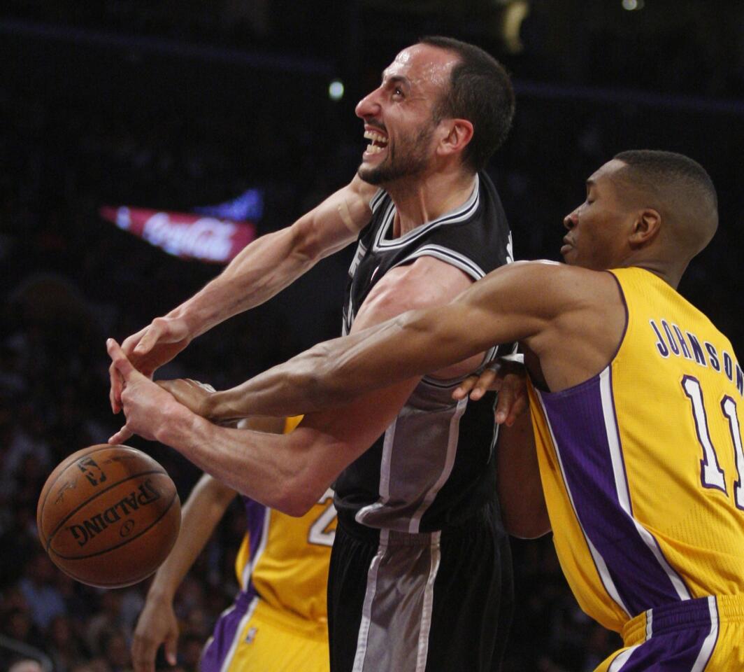 Lakers forward Wesley Johnson strips the ball from Spurs guard Manu Ginobili on a shot attempt in the first half Wednesday night at Staples Center.