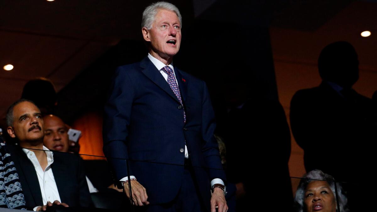 Former President Bill Clinton stands in the audience on the first day of the Democratic National Convention in Philadelphia on July 25.