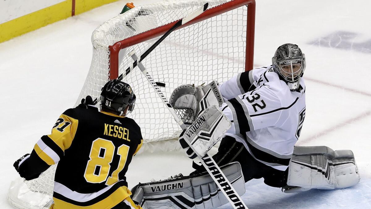 Pittsburgh Penguins' Phil Kessel (81) puts the game-winning goal behind Kings goaltender Jonathan Quick (32) in overtime.