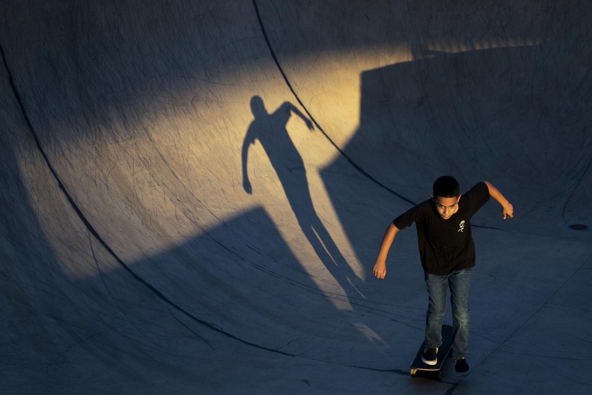 Jonah Medina skates amid a stream of sunlight.