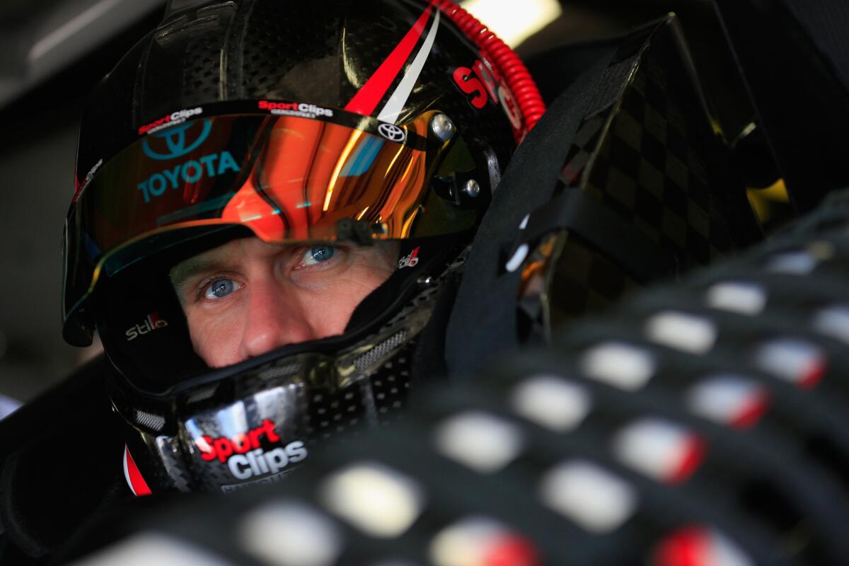 NASCAR driver Carl Edwards sits in his car during a practice for the Sprint Cup Series Sylvania 300 at New Hampshire Motor Speedway on Sept. 26.