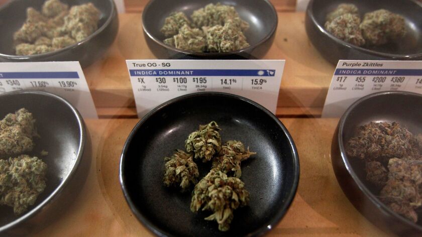 Different types of marijuana sit on display at Harborside marijuana dispensary in Oakland. A bill that would have allowed cities to block home deliveries stalled this week.