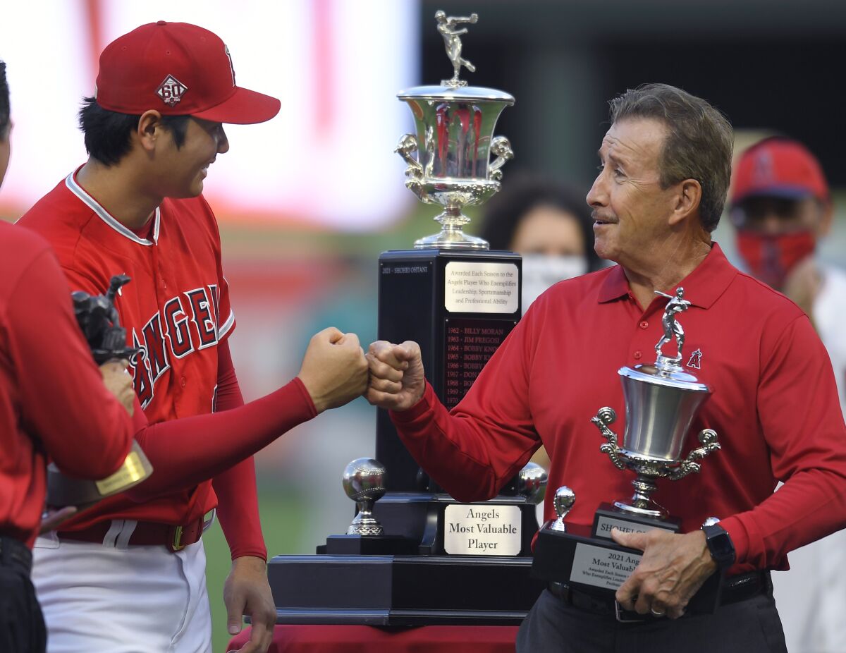 Angels star Shohei Ohtani gets a fist bump from team owner Arte Moreno after being named the Angels' most valuable player.