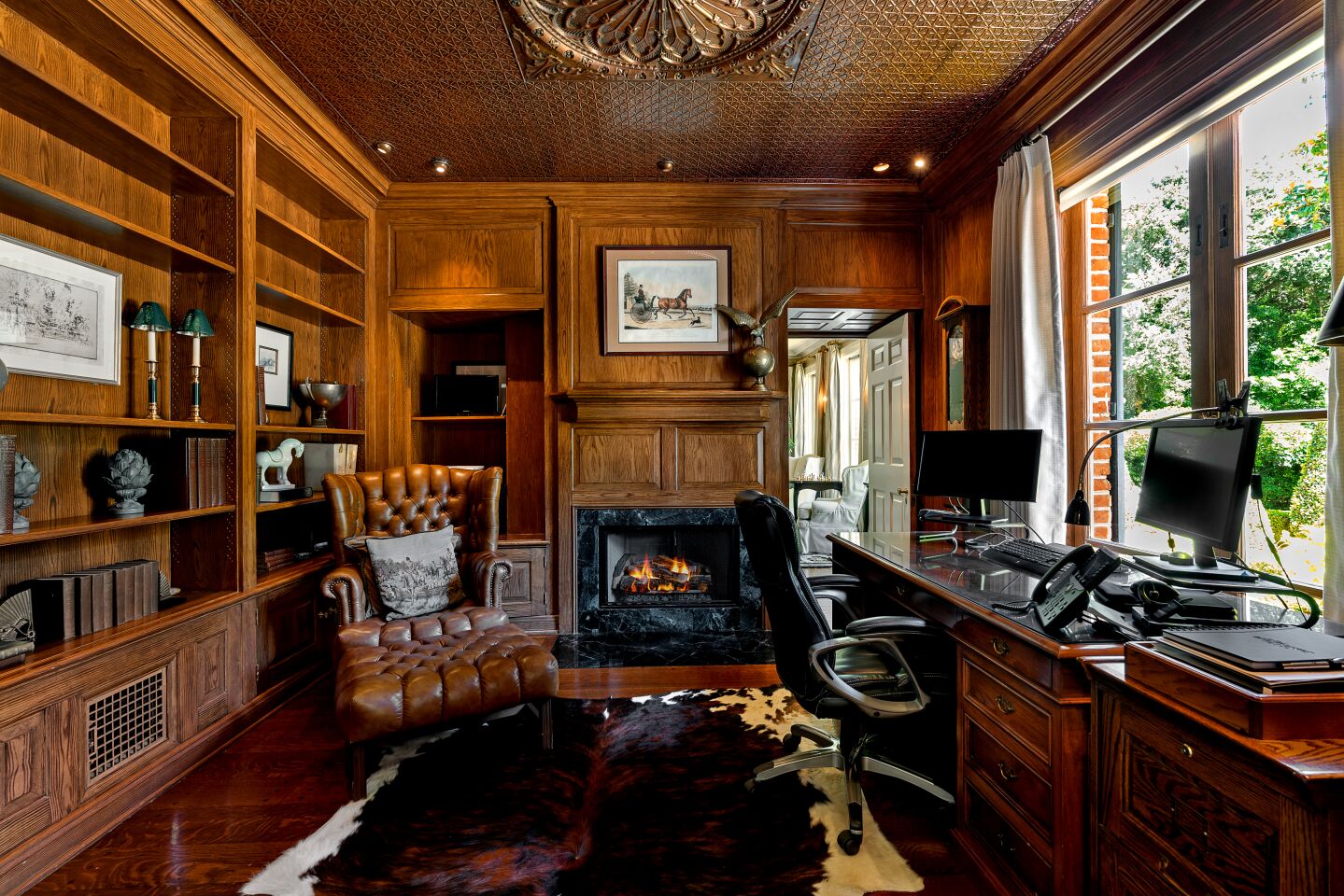 Fireplaces grace the living room, the wood-paneled library and the family room.