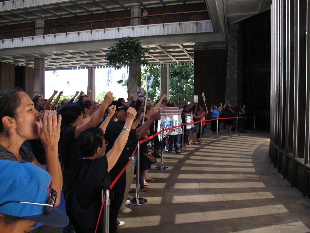 Proponents and opponents of same-sex marriage chant inside the Hawaii Capitol in Honolulu on Nov. 6, 2013