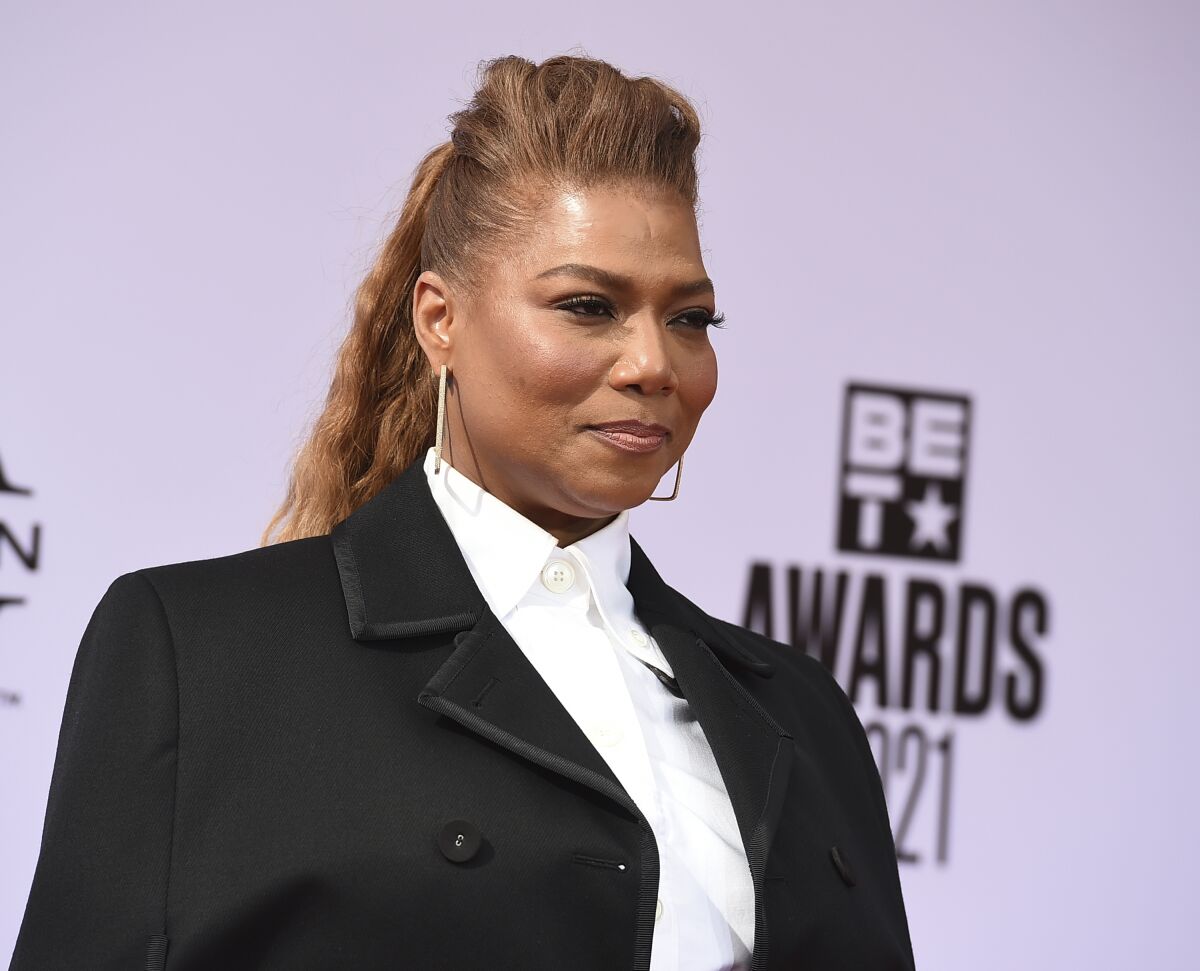A woman in a white blouse and black blazer