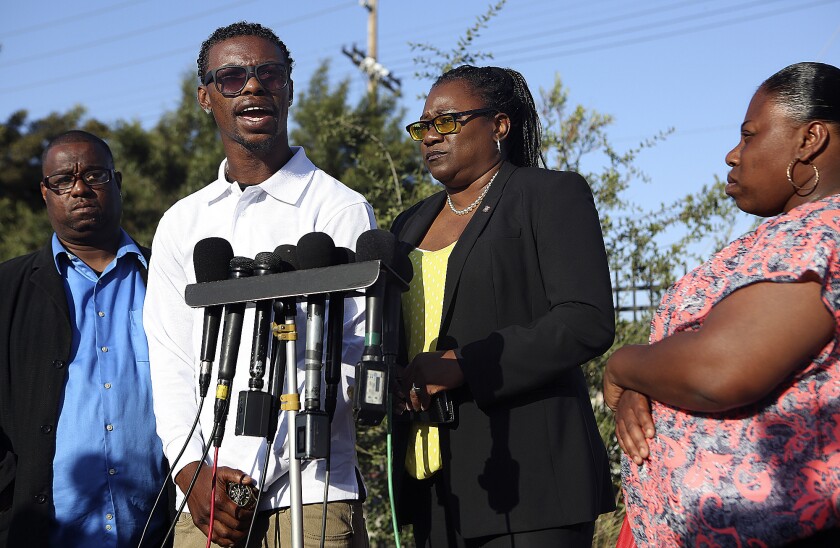 Clinton Alford Jr., second from left, addresses journalists with his attorney Caree Harper, third from left, and his family last year when prosecutors charged LAPD Officer Richard Garcia with assaulting him.