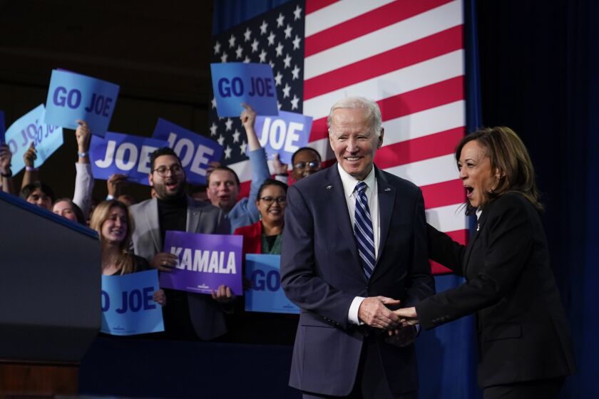 President Joe Biden is greeted by Vice President Kamala Harris as he walks onstage to speak at the Democratic National Committee Winter Meeting, Friday, Feb. 3, 2023, in Philadelphia. (AP Photo/Patrick Semansky)