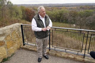 Interior Secretary David Bernhardt takes reporters' questions overlooking the Minnesota River area after he announced the gray wolf's recovery "a milestone of success during a stop at the Minnesota Valley National Wildlife Refuge, Thursday, Oct. 29, 2020, in Bloomington, Minn. The move stripped Endangered Species Act protections for gray wolves in most of the U.S., ending longstanding federal safeguards and putting states and tribes in charge of overseeing the predators. (AP Photo/Jim Mone)