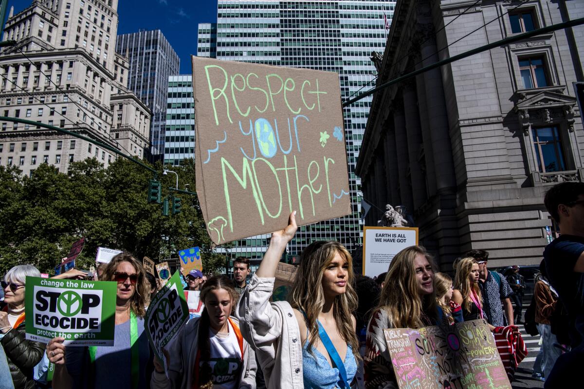 Activists walk through lower Manhattan for the Global Climate Strike protests on Sept. 23, 2022 in New York.