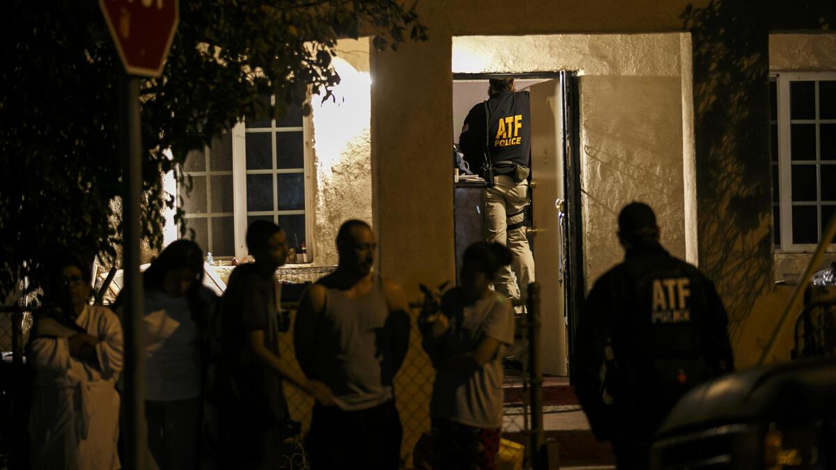 ATF agents search for evidence during a raid on a home in the San Fernando Valley on Nov. 2, 2016.