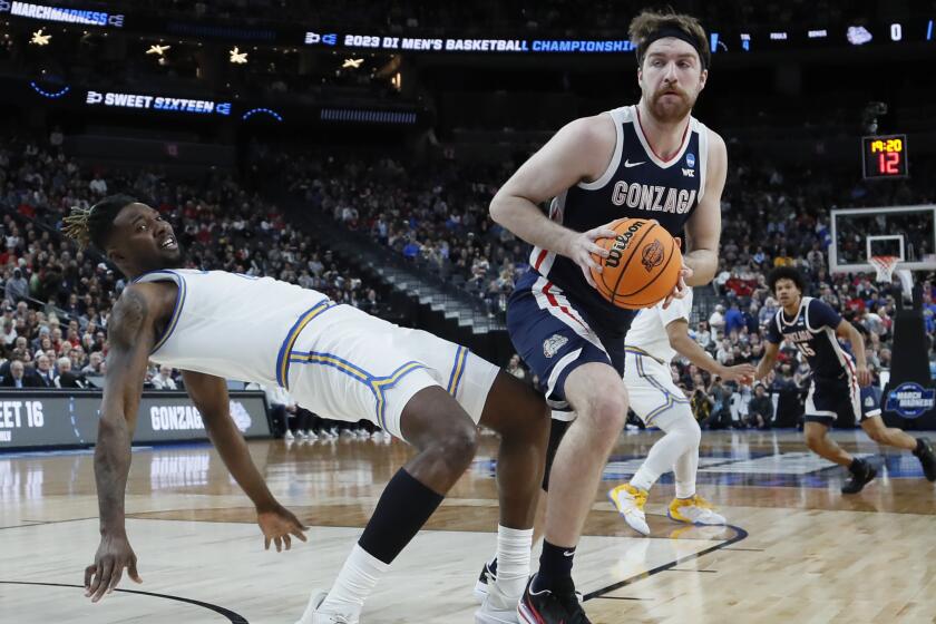 UCLA Bruins forward Kenneth Nwuba is knocked down by Gonzaga's Drew Timme in the NCAA Division 1 basketball tournament.