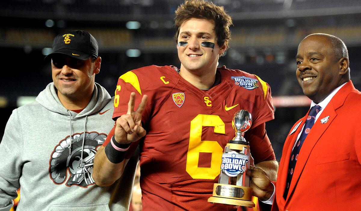 USC quarterback Cody Kessler, presented with the Holiday Bowl's award for offensive player of the game, has announced he'll return for his senior season.