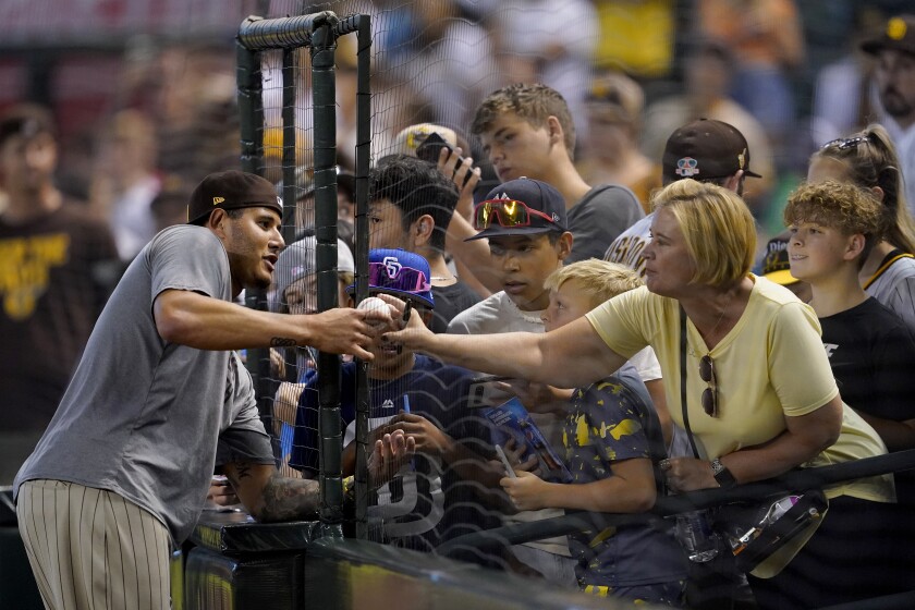 Padres' Manny Machado signs autographs before Wednesday's game in Phoenix.
