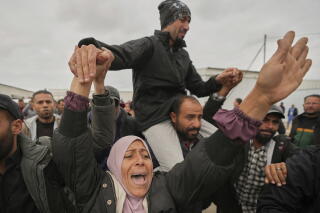 Freed Palestinian prisoners are greeted by a crowd as they arrive in the Gaza Strip after being released.