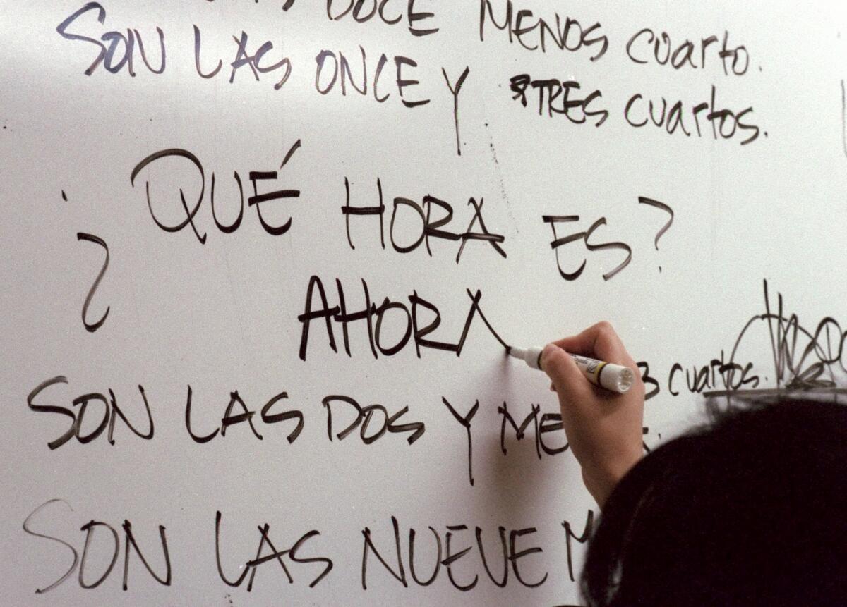 Spanish words being written on a whiteboard