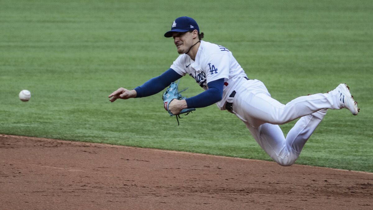 Dodgers second baseman Kiké Hernández dives to make a throw during the NLCS.