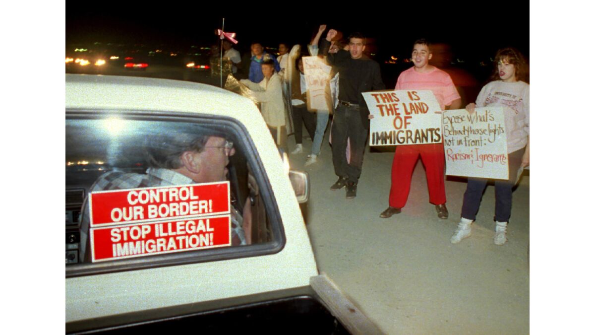 Nov. 12, 1993: Opposite sides of the immigration issue confront each other during a Light Up the Border rally in San Ysidro.