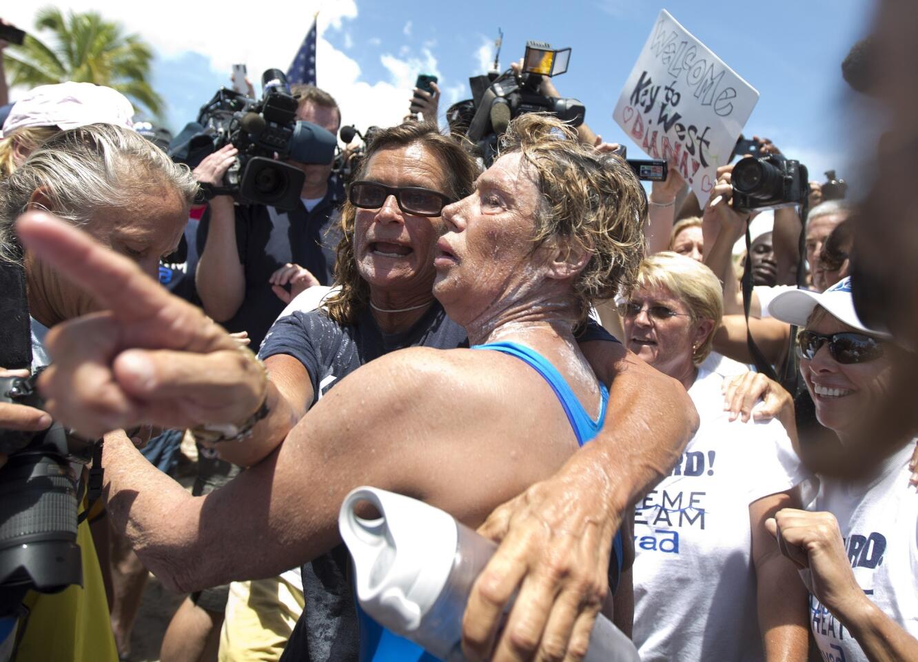 Endurance swimmer Diana Nyad, right, and her trainer Bonnie Stoll hug after Nyad walks ashore Monday in Key West, Fla., after swimming from Cuba. Nyad became the first person to swim from Cuba to Florida without the help of a shark cage.