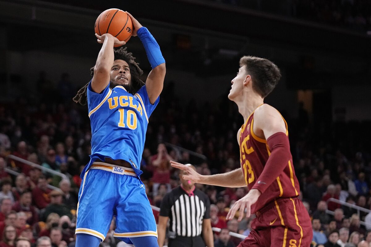 UCLA guard Tyger Campbell shoots in front of USC guard Drew Peterson during the first half Thursday.
