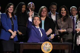 Florida Gov. Ron DeSantis throws markers into the audience after signing various bills during a bill signing ceremony at the Coastal Community Church at Lighthouse Point, Tuesday, May 16, 2023, in Lighthouse Point, Fla. (AP Photo/Wilfredo Lee)