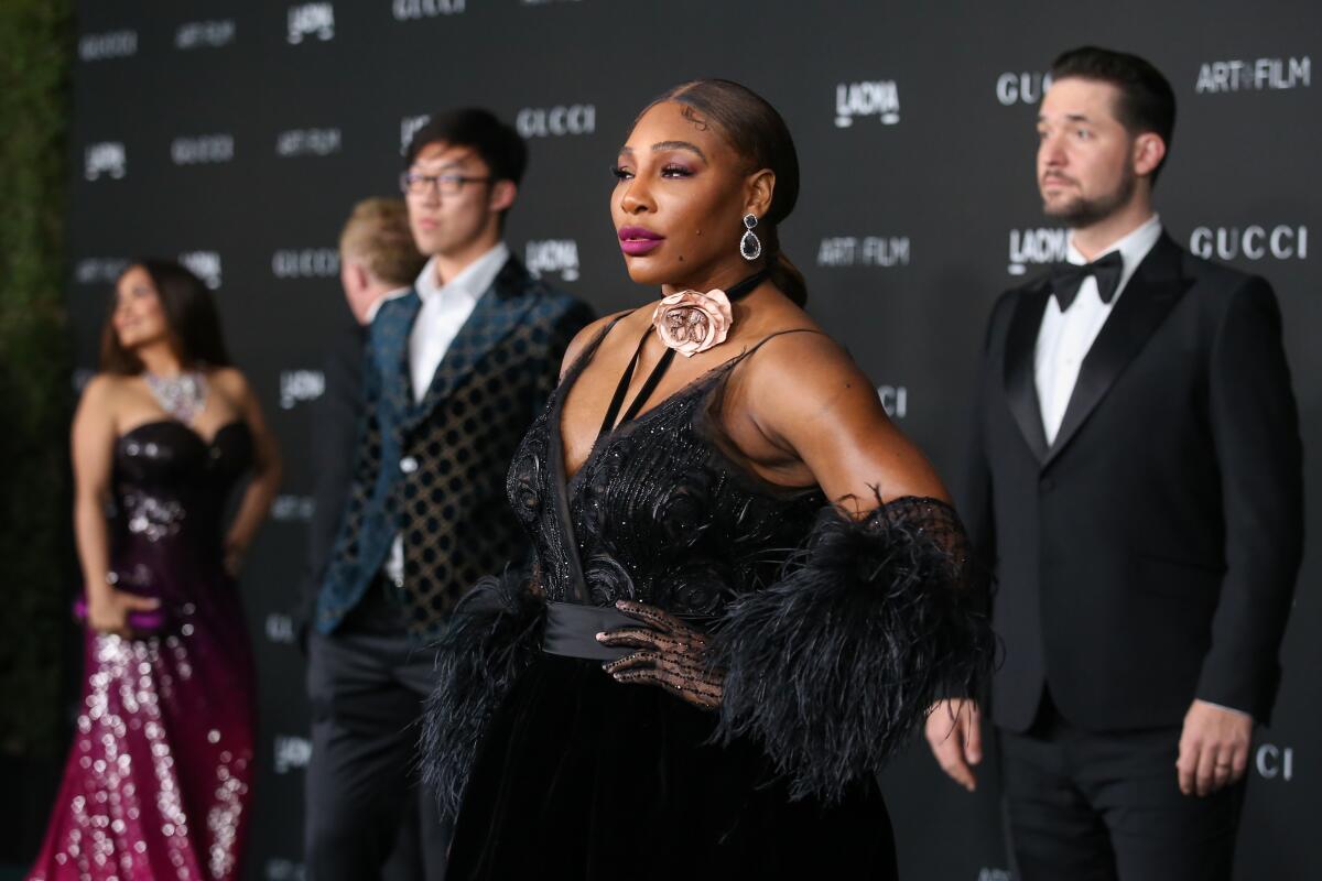 Serena Williams poses for photos at the 10th LACMA Art+Film Gala, while husband Alexis Ohanian looks on. 